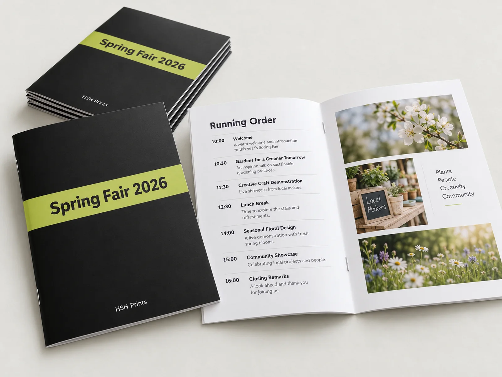 Mockup of A5 stapled event programme booklets, black covers with a lime Spring Fair 2026 band, one open at the running order