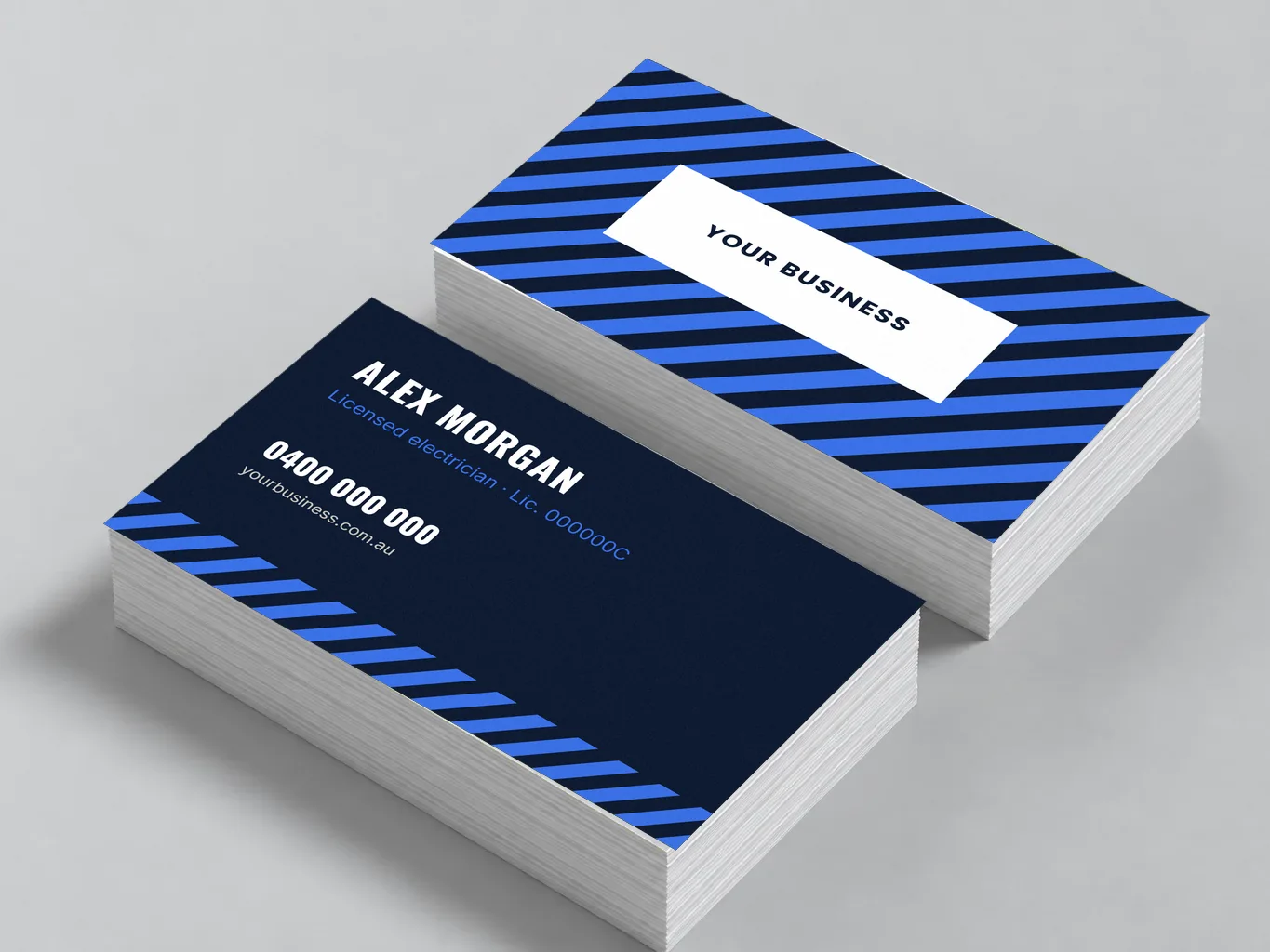 Mockup of two stacks of blue tradie business cards, front and back