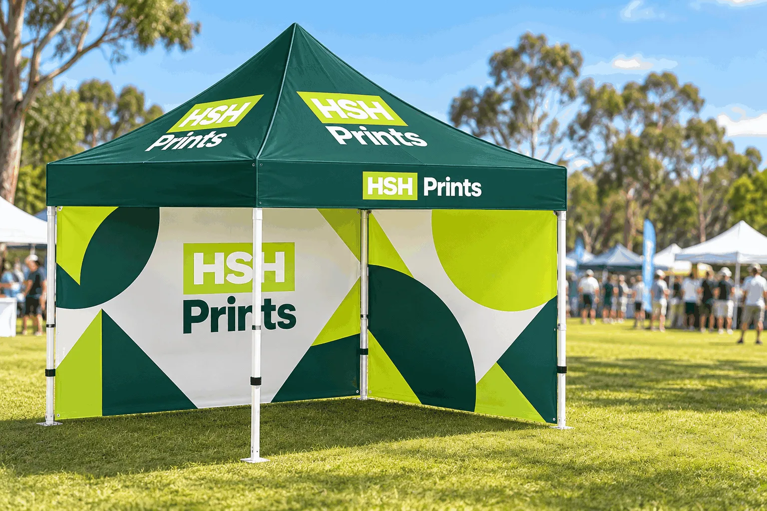 A 3 x 3m printed gazebo on a sports ground, dark green canopy with the HSH Prints logo, a printed back wall and side wall