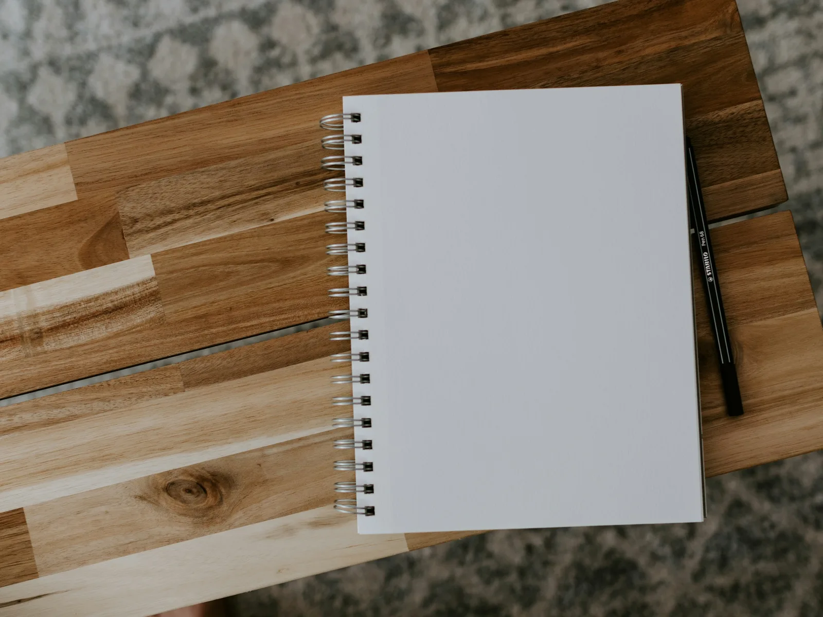 A notepad lying on a wooden table