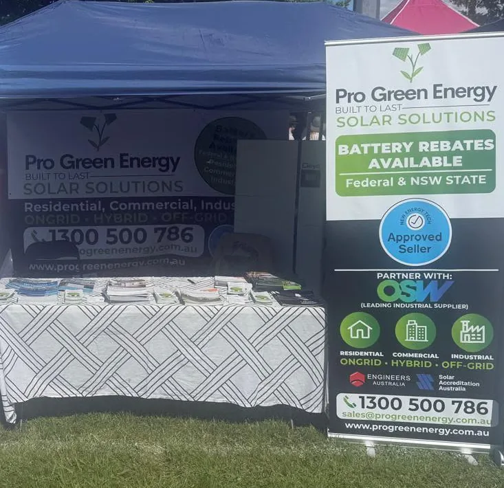 A pull-up banner we printed for a solar company, standing beside their gazebo stall at an outdoor expo